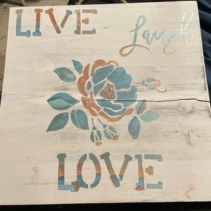 Hand-painted live laugh love sign in blue and rose gold with hints of green sign